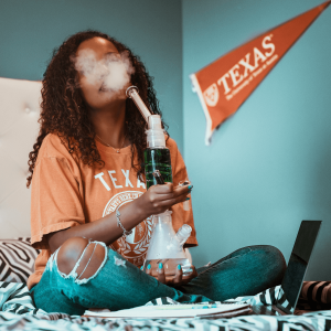 a girl in a dorm room smoking in a dorm room