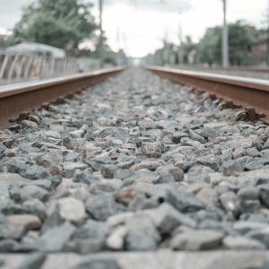 gray gravel in-between railroad tracks