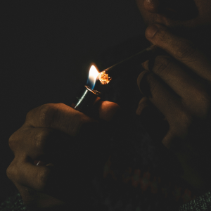 a person lighting a joint