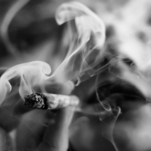 black and white photo of a woman smoking a joint