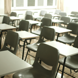 white desk chairs in a classroom