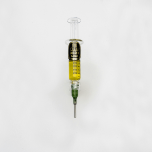 gold CBD distillate in a syringe