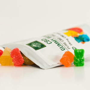 a white and green bag of CBD gummies