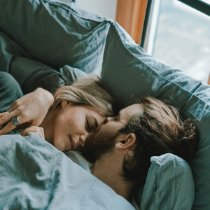 a man and woman laying in bed together