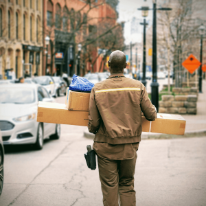 a delivery person carrying boxes