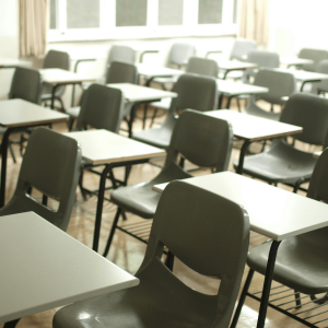 white desks and chairs in a classroom