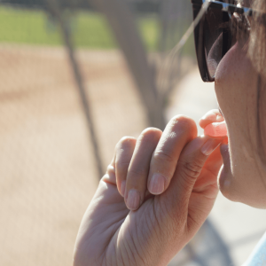 a girl putting a pink gummy in her mouth