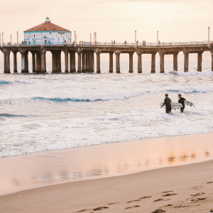 two surfers next to the pier in Manhattan Beach California