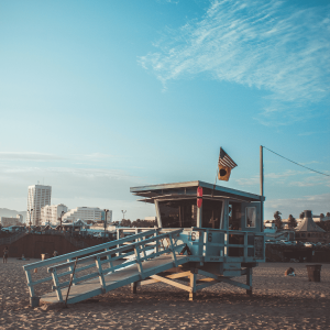 an american flag waving on a beach lifeguard tower