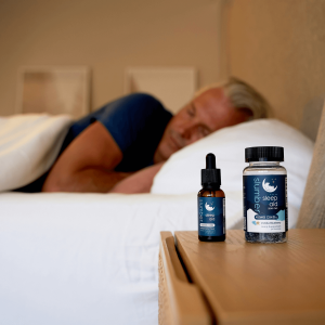 a man sleeping with CBD sleep products on the nightstand