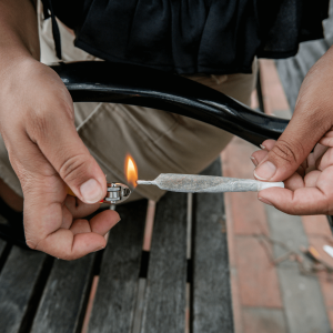 a man lighting a joint with a lighter