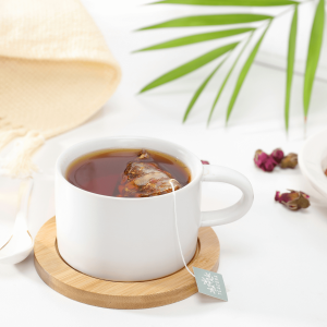 white ceramic mug with brown liquid inside