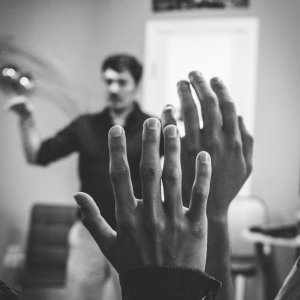 black and white image of two people raising hands