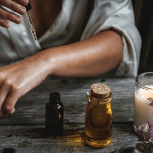 a woman applying an oil to her forearm