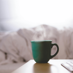 green mug on a nightstand