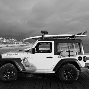 lifeguard jeep with a surfboard on top