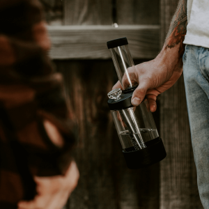 a person holding a clean glass bong