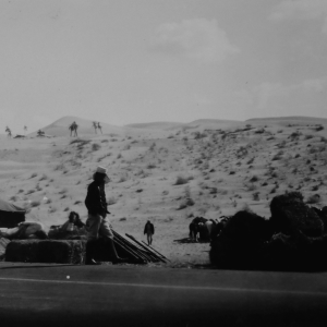 an old black and white photo of tents and horses