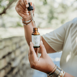 a person holding a bottle of CBD oil 