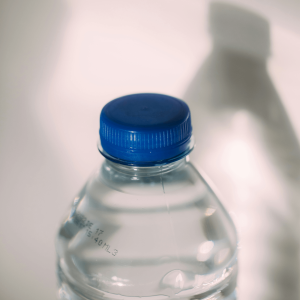 a clear plastic water bottle with a blue cap