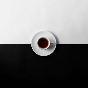 a cup of tea on a black and white table