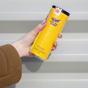 hand holding a yellow cannabis beverage can