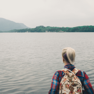 a girl looking across a lake