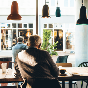 man sitting at a table in a cafe