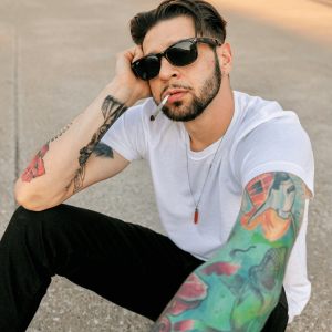 man with white shirt smoking a joint