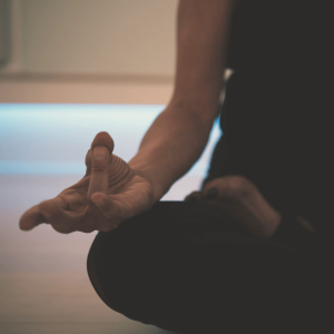 a person meditating on the floor