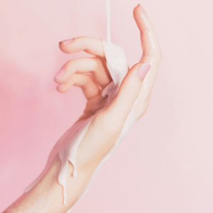 a woman’s hand covered in white lotion