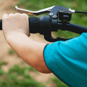 a person’s hand on a bike handle