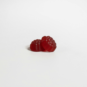 two red gummies against a white background