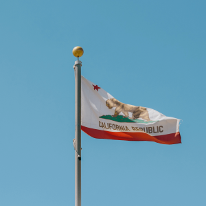 California flag flowing against a blue sky