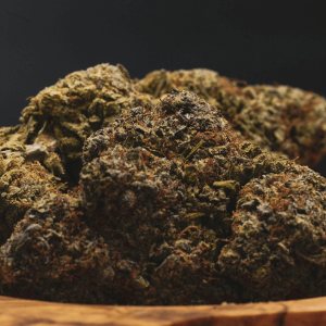 large cannabis buds on a wooden tray