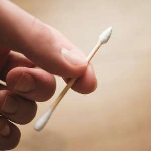 a hand holding a cotton swab