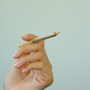 hand holding pre-rolled joint