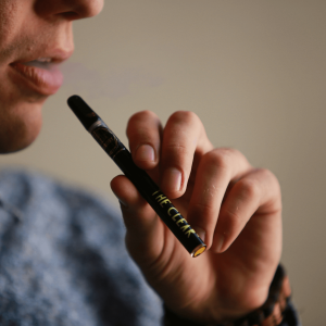 man smoking from a cannabis vape pen