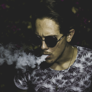 man in sunglasses vaping