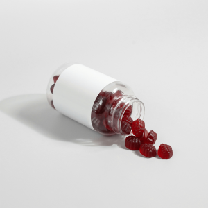 red gummies in a white labeled bottle