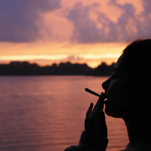 girl smoking joint at sunset