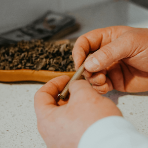 hands rolling a joint
