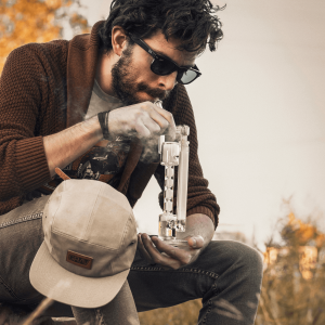 man smoking from glass bong
