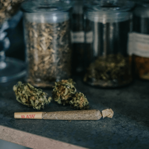 joint and cannabis flower in jars