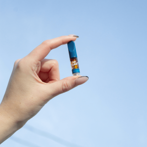 hand holding blue vape cart