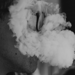 greyscale image of man smoking