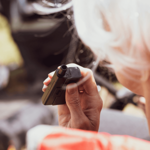 woman holding black weed vape