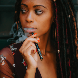 woman vaping from weed pen