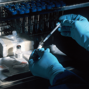 person in lab with syringe