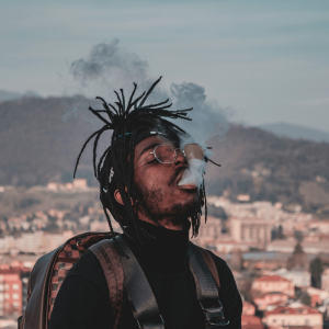 man blowing out smoke